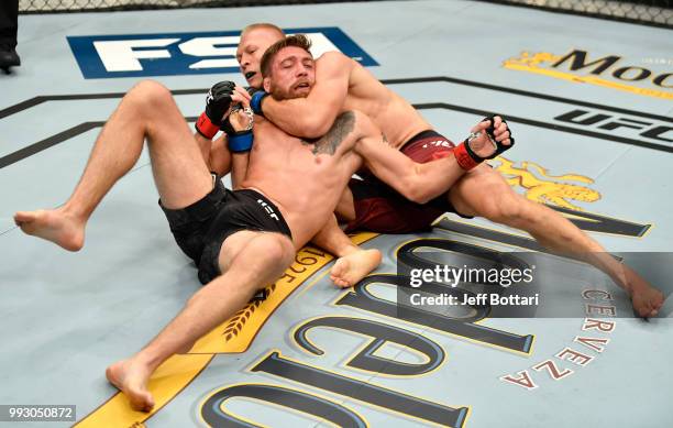 Oskar Piechota of Poland attempts to secure a choke submission against Gerald Meerschaert in their middleweight bout during The Ultimate Fighter...