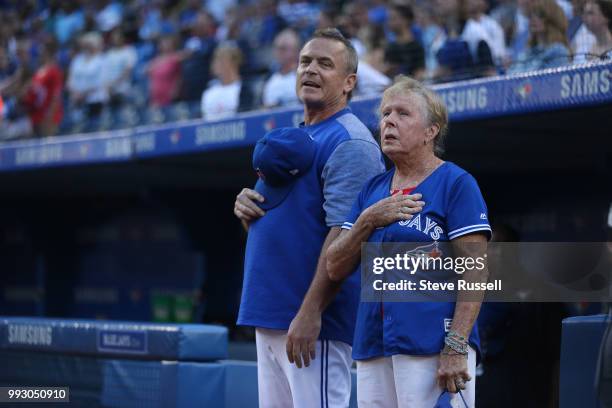 Toronto Blue Jays manager John Gibbons listens to the anthems with his mother Sally who threw out the first pitch before the game as theToronto Blue...