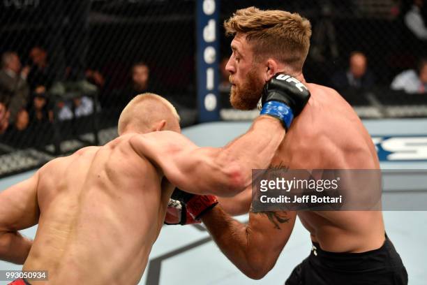 Gerald Meerschaert and Oskar Piechota of Poland trade punches in their middleweight bout during The Ultimate Fighter Finale event inside The Pearl...