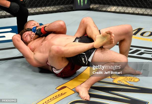 Oskar Piechota of Poland attempts to secure a choke submission against Gerald Meerschaert in their middleweight bout during The Ultimate Fighter...