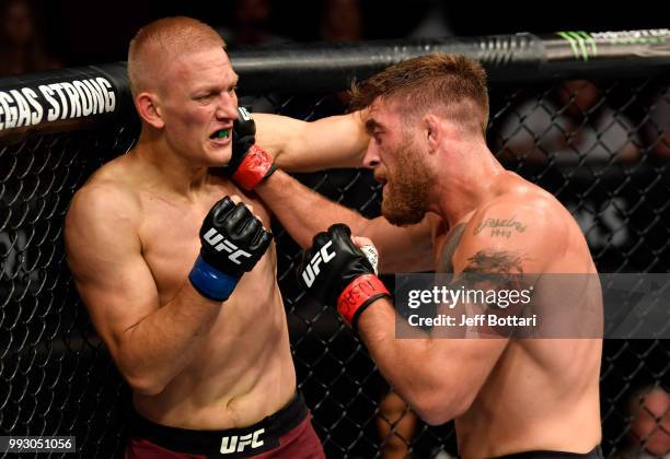 Gerald Meerschaert and Oskar Piechota of Poland trade punches in their middleweight bout during The Ultimate Fighter Finale event inside The Pearl...