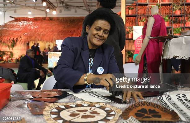 Representative of the Fiji Islands performs traditional artisanal craft at the World Climate Conference in Bonn, Germany, 6 November 2017. The World...