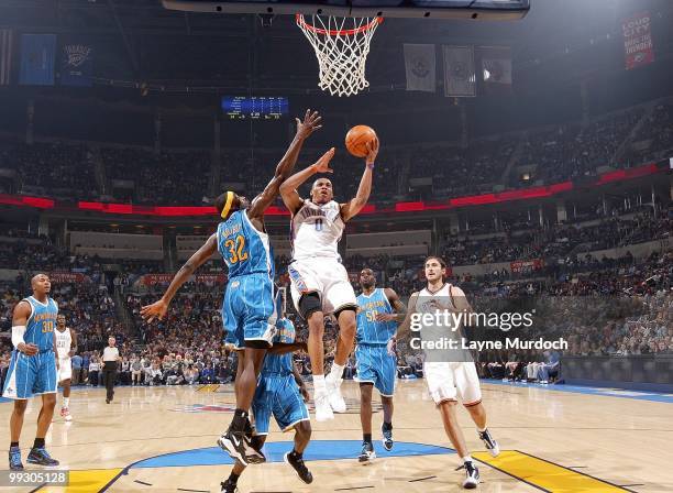 Russell Westbrook of the Oklahoma City Thunder makes a layup against Julian Wright of the New Orleans Hornets during the game at Ford Center on March...