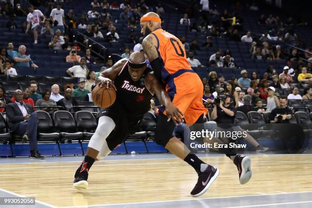 Al Harrington of Trilogy drives with the ball against Drew Gooden of 3's Company during week three of the BIG3 three on three basketball league game...