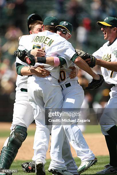 Dallas Braden, Landon Powell, Daric Barton and Adam Rosales of the Oakland Athletics celebrating after Braden pitched a perfect game against the...