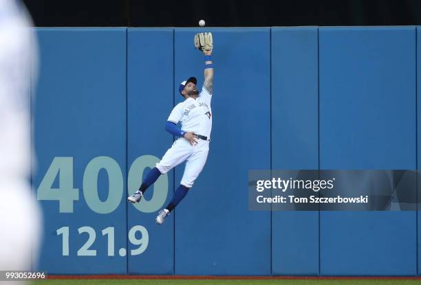 Kevin Pillar of the Toronto Blue Jays makes a leaping catch against the wall in the second inning during MLB game action against the New York Yankees...