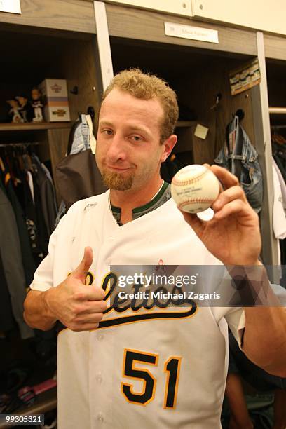 Dallas Braden of the Oakland Athletics poses with the game winning ball in the clubhouse after pitching a perfect game against the Tampa Bay Rays at...