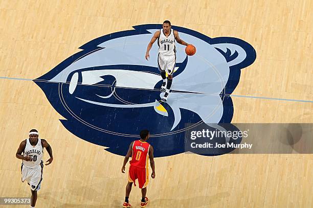 Mike Conley of the Memphis Grizzlies dribbles the ball against the Houston Rockets during the game at the FedExForum on April 6, 2010 in Memphis,...