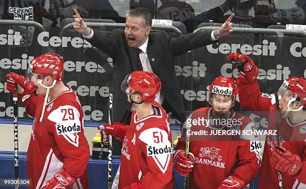 Denmark's Swedish coach Per Backman celebrates with Denmarks players Morten Madsen, Frans Nielsen, Mads Christensen and Peter Regin after the IIHF...