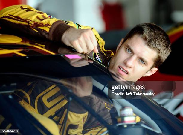 David Ragan, driver of the UPS Ford, climbs in his car in the garage during practice for the NASCAR Sprint Cup Series Autism Speaks 400 at Dover...