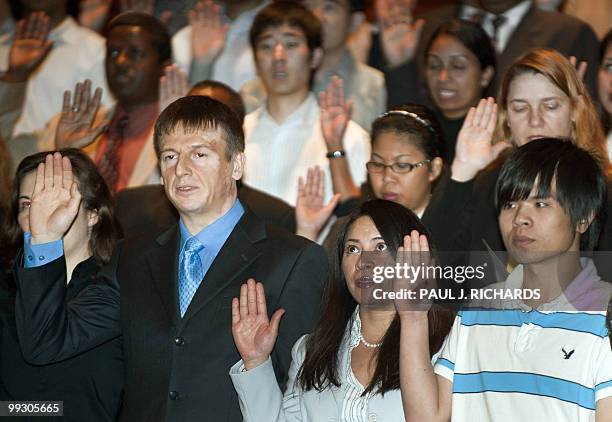 Some of the 75 newest US citizens are sworn-in during naturalization ceremonies May 14 inside Fairfax County, Virginia's Government Center. The new...