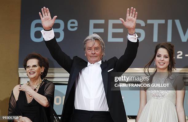 French actor Alain Delon, his daughter Anoushka and Italian actress Claudia Cardinale arrive for the screening of "Il Gattopardpo" presented during a...