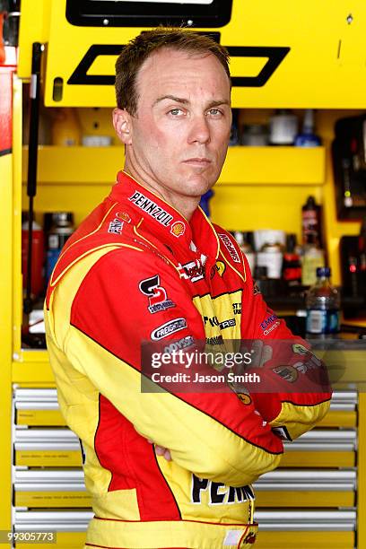 Kevin Harvick, driver of the Shell/Pennzoil Chevrolet, stands in the garage during practice for the NASCAR Sprint Cup Series Autism Speaks 400 at...