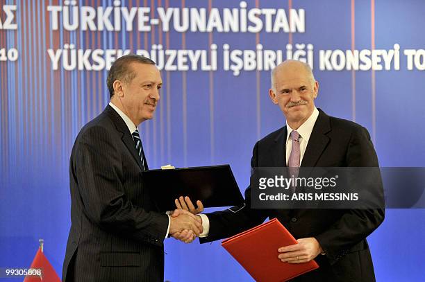 Greek Prime Minister George Papandreou and his Turkish counterpart Recep Tayyip Erdogan shake hands after signing an agreement in Athens on May 14,...