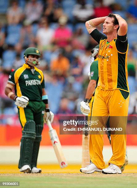 Australian bowler Shaun tait reacts as Pakistani captain Shahid Afridi and batsman Umar Akmal celebrate a boundary during the ICC World Twenty20...