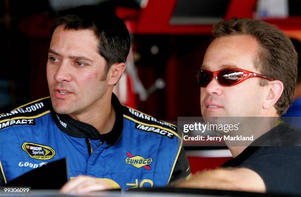 David Stremme , driver of the Air Gaurd Ford, talks with crew chief Frankie Stoddard in the garage during practice for the NASCAR Sprint Cup Series...