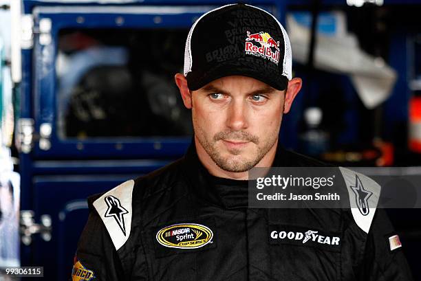 Casey Mears, driver of the Red Bull Toyota, stands in the garage during practice for the NASCAR Sprint Cup Series Autism Speaks 400 at Dover...