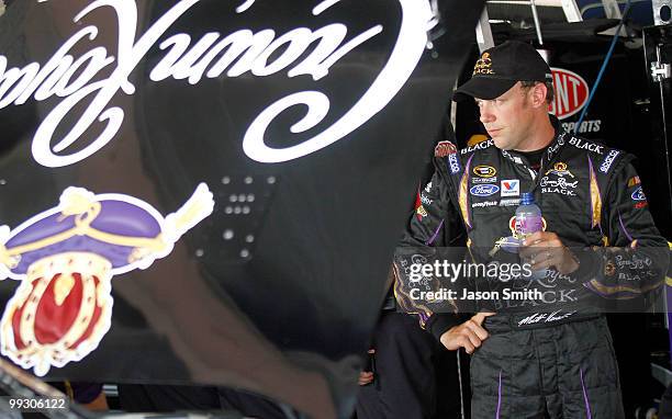 Matt Kenseth, driver of the Crown Royal Black Ford, stands in the garage area during practice for the NASCAR Sprint Cup Series Autism Speaks 400 at...