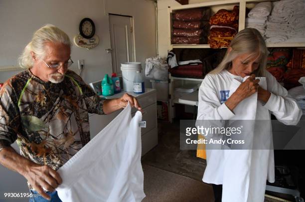 Spring fire evacuees Dave and Judy Lemay fold up laundry at The Lodge Motel in Fort Garland July 06, 2018. Both are staying at the motel free of...