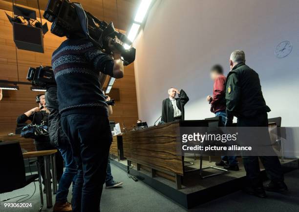 The accused, Hussein K. , being brought in handcuffs into a courtroom of the District Court in Freiburg, Germany, 07 November 2017. The murder trial...