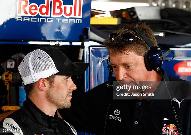 Casey Mears , driver of the Red Bull Toyota speaks with crew chief Ryan Pemberton , in the garage area during practice for the NASCAR Sprint Cup...