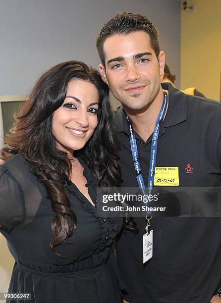 Festival Producer Janeen Mansour and actor Jesse Metcalfe help children design the Noble Humanitarian award trophies at the Art of Elysium workshop...