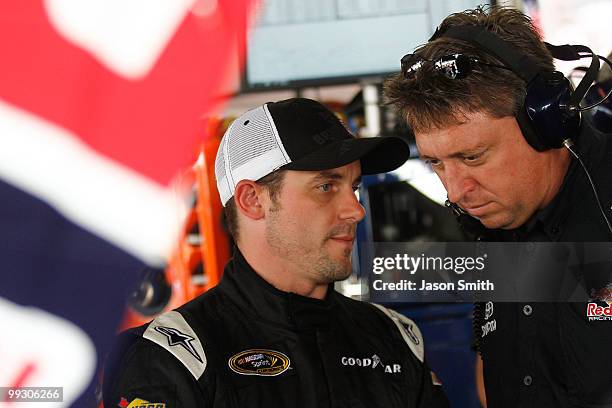 Casey Mears , driver of the Red Bull Toyota speaks with crew chief Ryan Pemberton , in the garage area during practice for the NASCAR Sprint Cup...