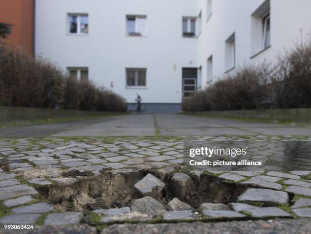Hole in the pavement can be seen at Rungiusstrasse 33 in Berlin, Germany, 7 November 2017. 'Stumbling blocks' , which remembers the victims of...