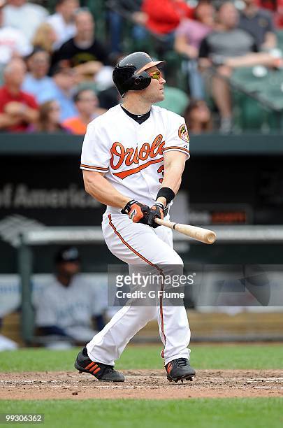 Luke Scott of the Baltimore Orioles hits a grand slam home run in the eighth inning against the Seattle Mariners at Camden Yards on May 13, 2010 in...