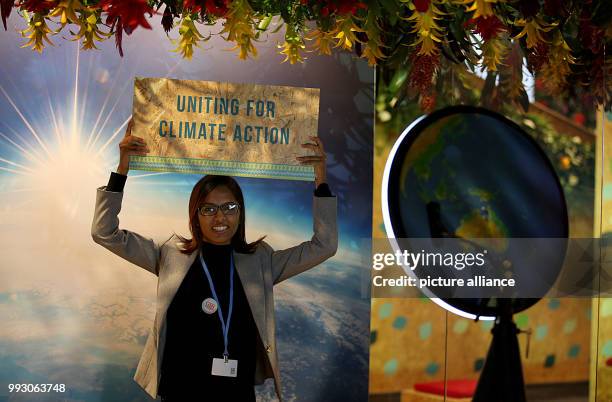 Woman showing a sign advertising a blog entry on climate change during the World Climate Conference in Bonn, Germany, 07 November 2017. The World...