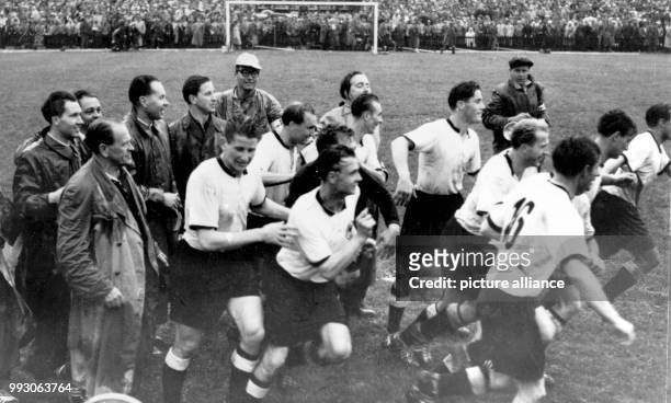 - An archive picture, dated 4 July 1954, shows German trainer Sepp Herberger looking on the rejoicing victors who run towards the espectators, Max...