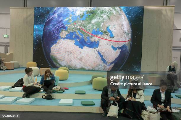 Participants in the World Climate Conference working in front of the depiction of a globe in Bonn, Germany, 07 November 2017. The World Climate...
