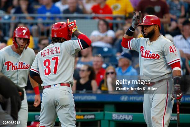 Odubel Herrera of the Philadelphia Phillies celebrates with Carlos Santana after hitting a three run home run in the third inning against the...
