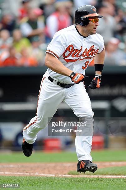 Luke Scott of the Baltimore Orioles runs the bases after hitting a grand slam home run in the eighth inning against the Seattle Mariners at Camden...