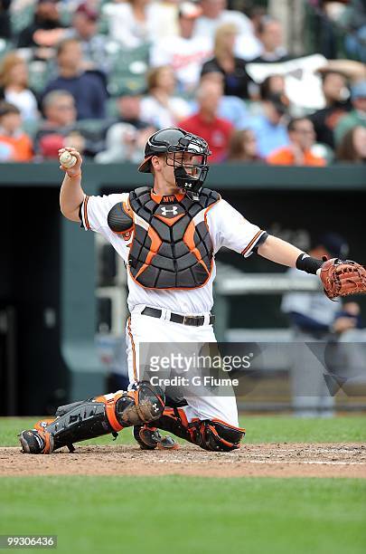 Matt Wieters of the Baltimore Orioles throws the ball back to the pitcher during the game against the Seattle Mariners at Camden Yards on May 13,...