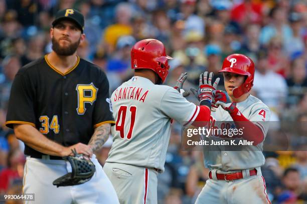 Scott Kingery and Carlos Santana of the Philadelphia Phillies celebrate after scoring on a two RBI double in the second inning against Trevor...