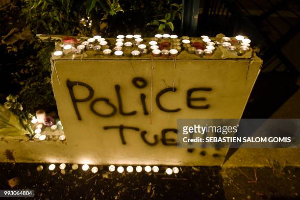Abou, the name of the young man who was shot dead by an officer during a police check on the night of July 3, is written with candles near the words...