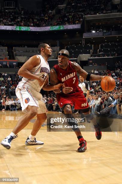 Jermaine O'Neal of the Miami Heat moves the ball against Boris Diaw of the Charlotte Bobcats during the game at Time Warner Cable Arena on March 9,...