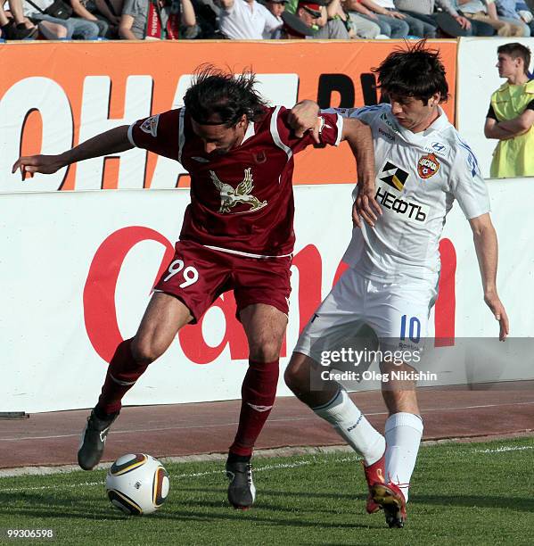 Hasan Kabze of FC Rubin Kazan battles for the ball with Alan Dzagoev of PFC CSKA Moscow in action during the Russian Football League Championship...