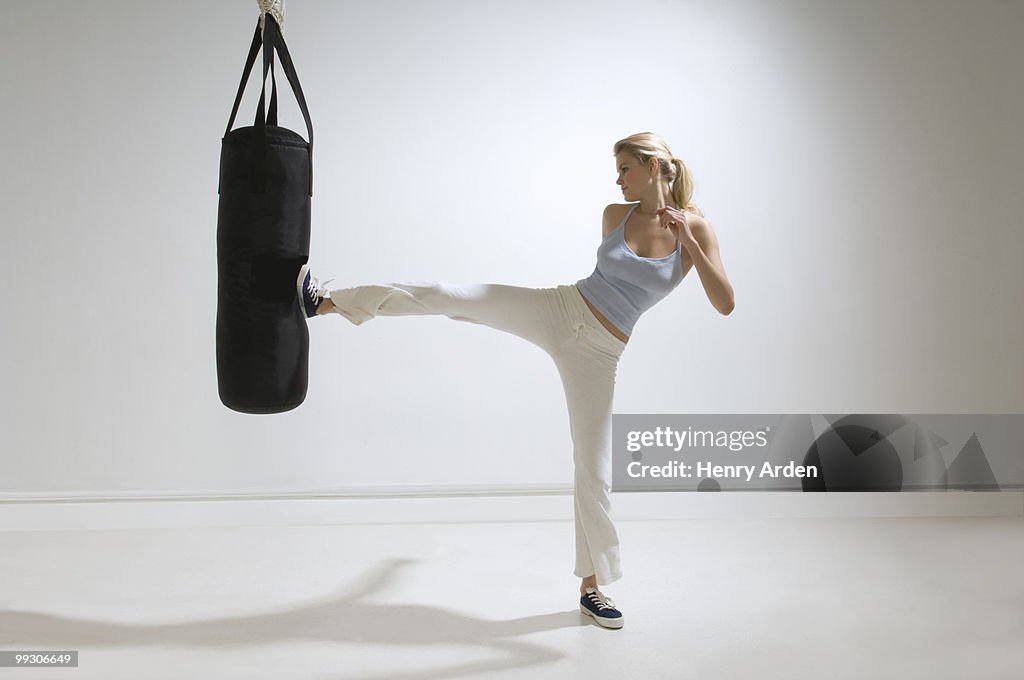 Female kicking punchbag