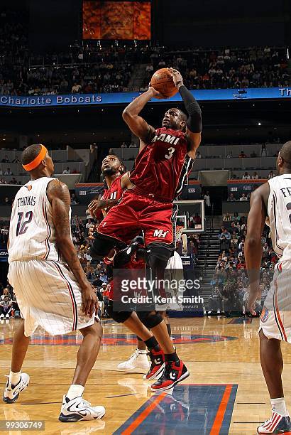 Dwyane Wade of the Miami Heat shoots a jumper against Tyrus Thomas of the Charlotte Bobcats during the game at Time Warner Cable Arena on March 9,...