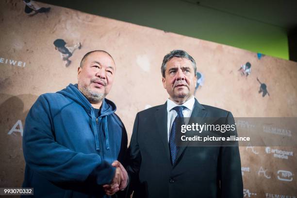 Chinese artist Ai Weiwei and German Minister of Foreign Affairs Sigmar Gabriel arrive at the Germany premiere of Ai Weiwei's movie 'Human Flow' in...