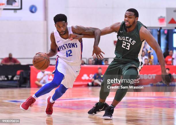 Larry Drew II of the Detroit Pistons drives against Sterling Brown of the Milwaukee Bucks during the 2018 NBA Summer League at the Cox Pavilion on...
