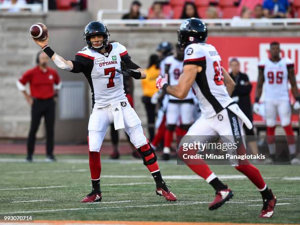 Quarterback Trevor Harris of the Ottawa Redblacks prepares to throw the ball against the Montreal Alouettes during the CFL game at Percival Molson...