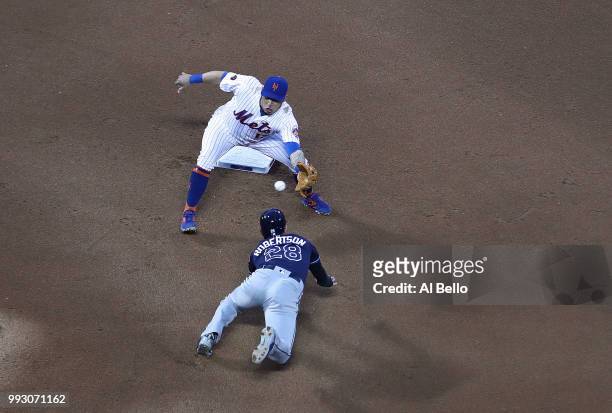 Asdrubal Cabrera of the New York Mets tags out Daniel Robertson of the Tampa Bay Rays on a steal attempt during their game at Citi Field on July 6,...