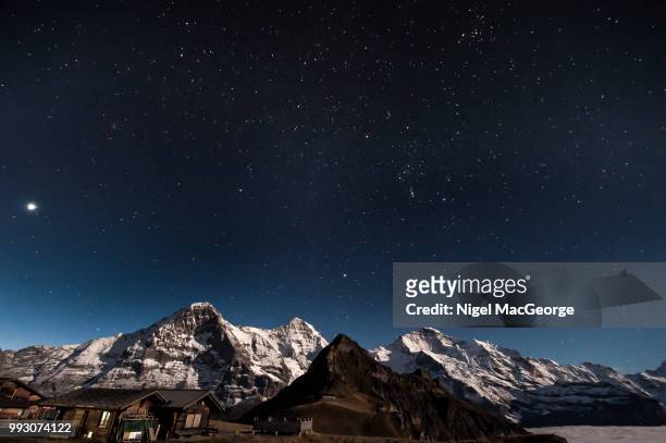 eiger monch jungfrau mannlichen by moonlight with stars - mannlichen stock pictures, royalty-free photos & images