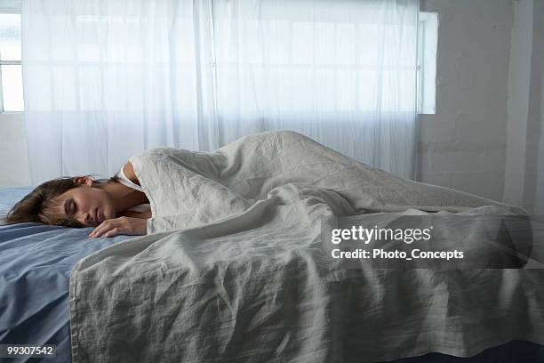 mujer joven en el "sleep mode", en la cama - acostado de lado fotografías e imágenes de stock