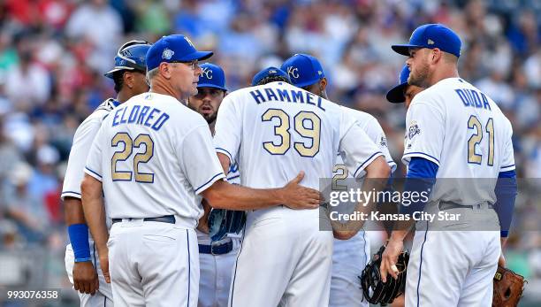 Kansas City Royals pitching coach Cal Eldred makes a visit to talk with starting pitcher Jason Hammel in the first inning against the Boston Red Sox...