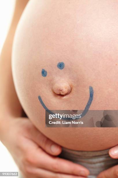 pregnant belly with smiley face - smiley face stock pictures, royalty-free photos & images