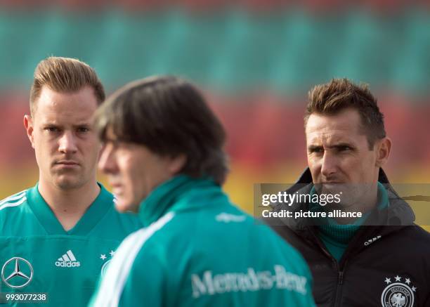 Intern Miroslav Klose and goalkeeper Marc-André ter Stegen observing Germany head coach Jogi Low ahead of the start of the German national soccer...